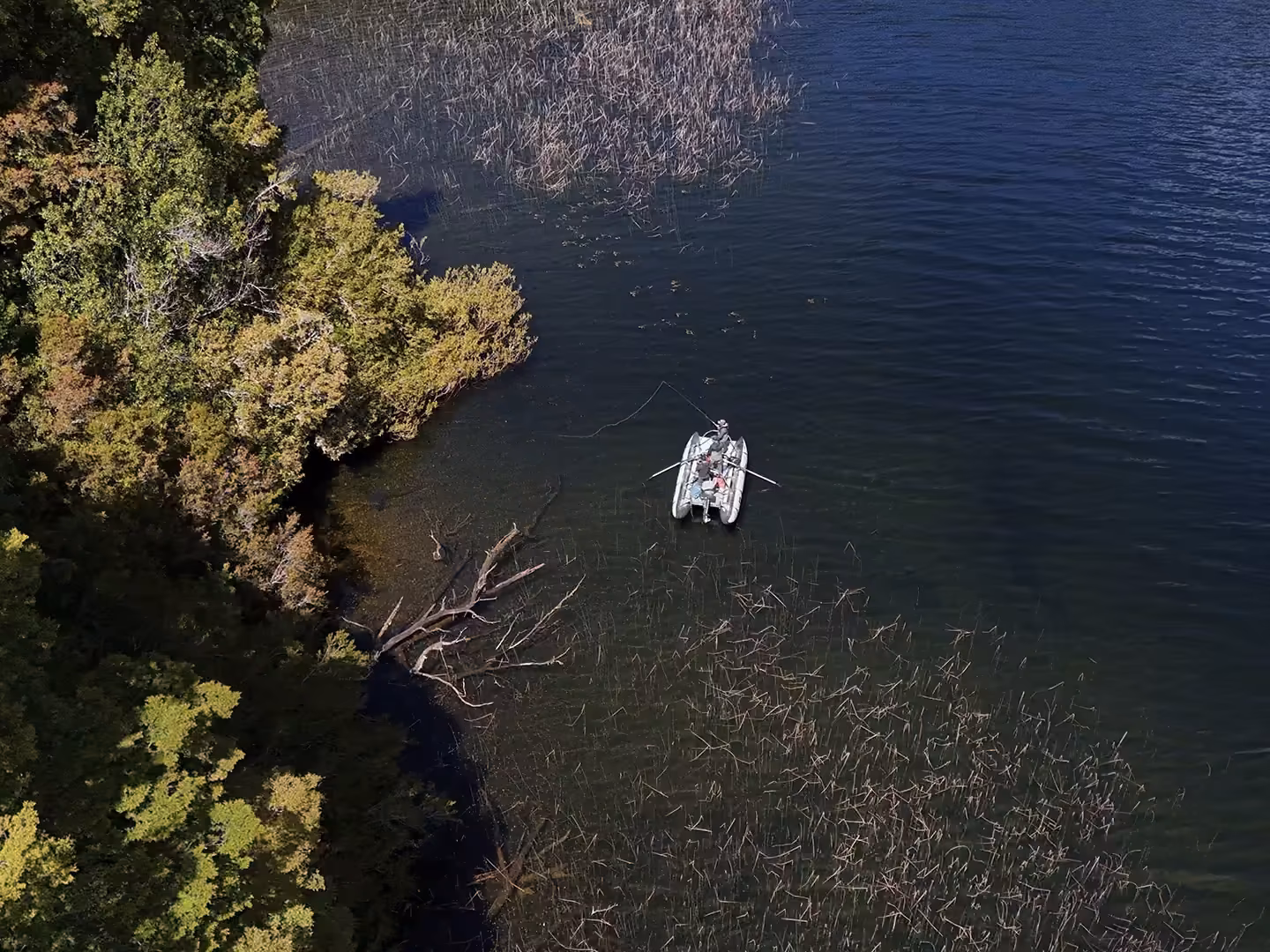 Drone view of a cataraft fly fishing at Lake Zenteno, Coyhaique