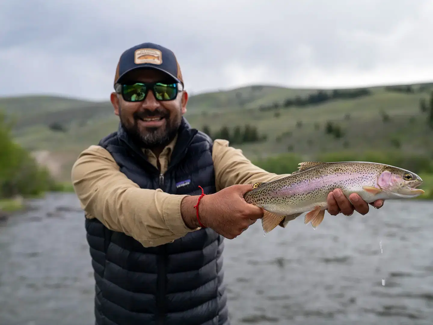 Chile Fly Fishing guide holding a wild rainbow trout on Montana's Madison River