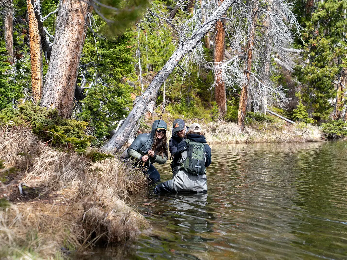 Anglers wading a backcountry alpine lake near Dubois, Wyoming